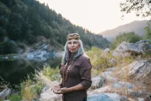 Margo Robbins portrait with forested mountains behind her